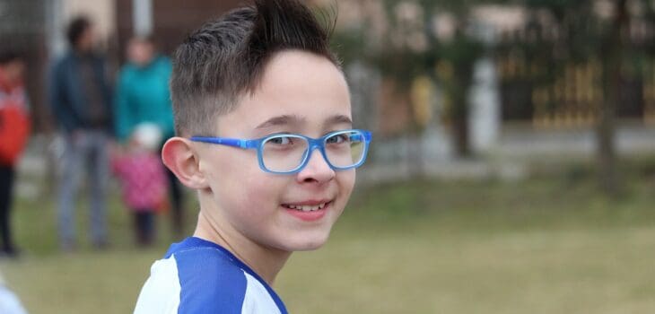boy athlete with blue glasses